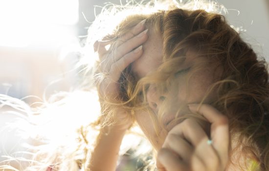 close-up-woman-covering-her-face-with-hair